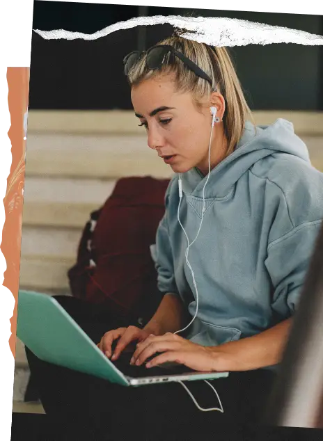 Stylized photo of a student wearing headphones using Blackboard LMS on her laptop