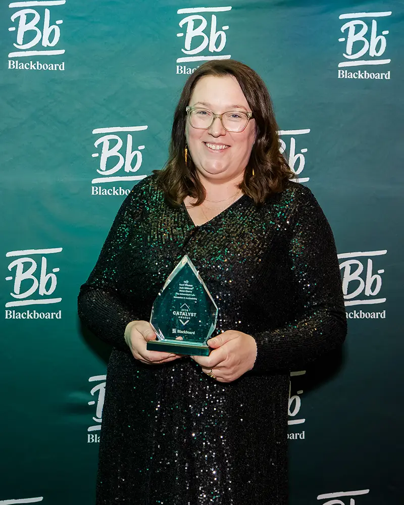 Representative from The University of Law accepting their Catalyst Award at Building Blackboard Together