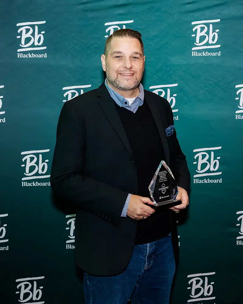 Representative from The University of Phoenix accepting their Catalyst Award at Building Blackboard Together